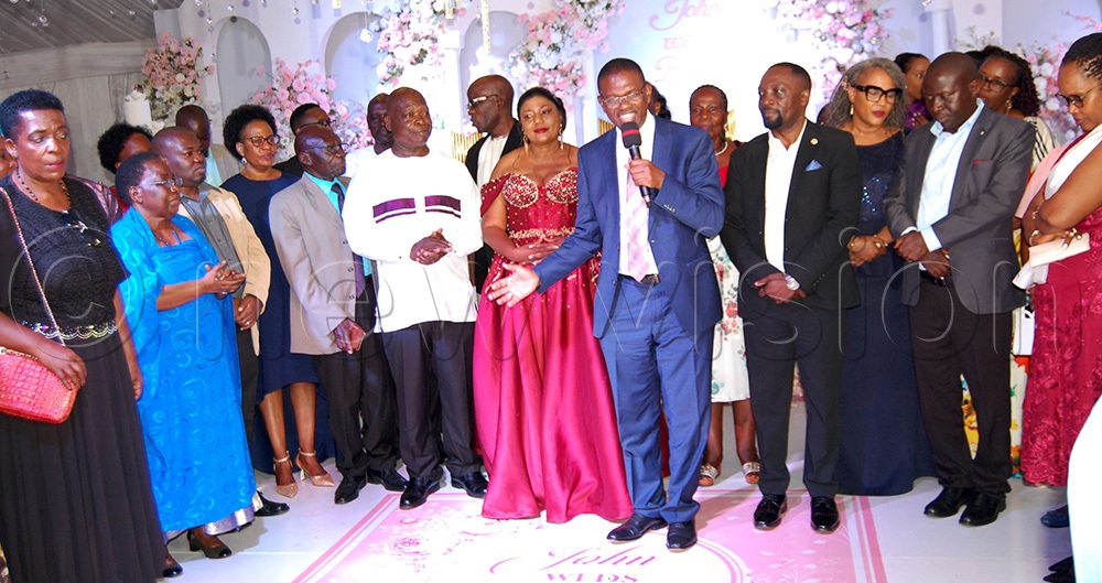 The Muwangas sharing a light moment with the Rotarians of Bbunga. (Photo by Mathias Mazinga)