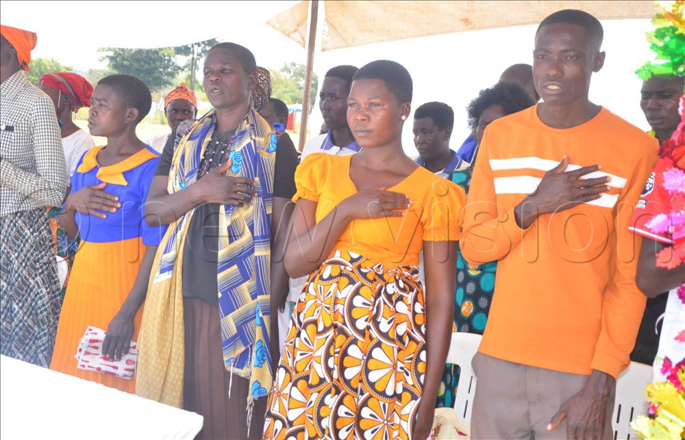 Parents trying to sing the Ateso Anthem.