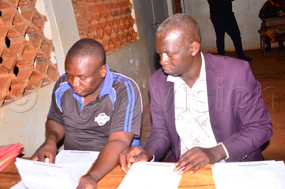  Ayub Wabika (R) with one of his agents as they arranged the declaration forms on arrival at the tally centre on Wednesday night. (Photo by Jackie Nambogga)