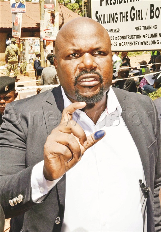Munyagwa showing the ink on his thumb  as a sign of voting. He cast his ballot at  Kikoni polling centre in Kampala