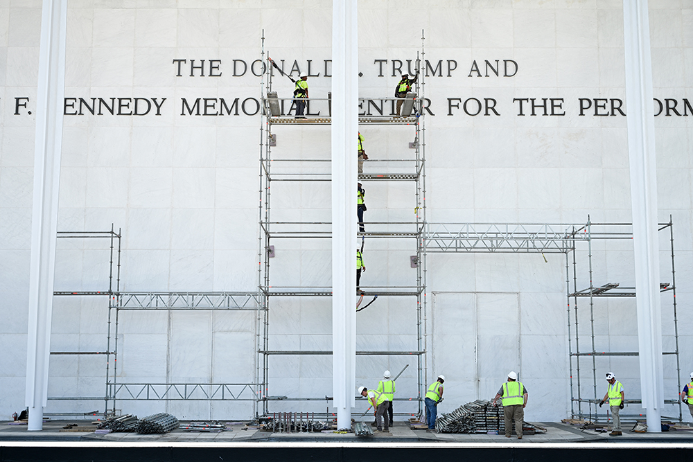 Workers build scaffolding near the signage for the "Donald J. Trump and John F. Kennedy Memorial Center for the Performing Arts" in Washington, DC, early on June 13, 2026. (AFP)