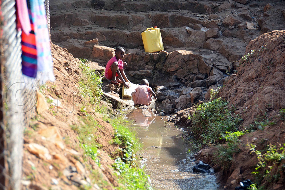 Children fetching water from a spring at Kironde Zone, Kabowa Parish in Rubaga Division, Kampala on Saturday December 6, 2025. The leaders of the area appealed to Kampala Capital City Authority to provide safe clean water for the community. (Photo by Francis Emorut)