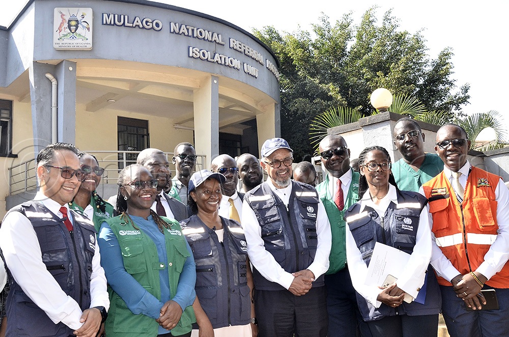 The Director-General of the World Health Organization (WHO), Dr. Tedros Adhanom Ghebreyesus (third right) poses for group photograph with staff of WHO, Africa CDC, Ministry of Health and Mulago Referral Hospital after the visited Mulago Referral Hospital Isolation Unit Mulago on June 8 2026. (Photo by Ronnie Kijjambu)
