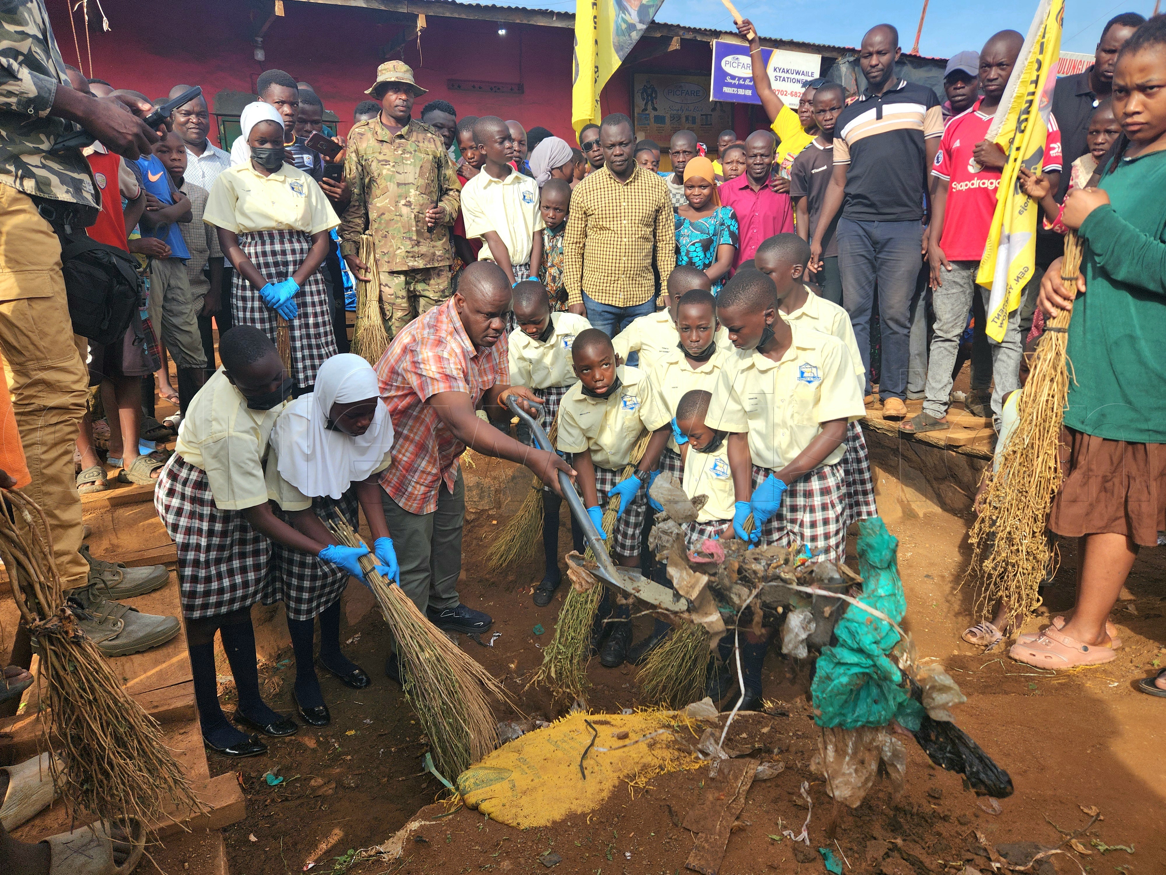 Donning his signature checked shirt, jeans and gumboots, Barugahara led residents, learners and security personnel in cleaning trenches, roads and stalls in an exercise that started at Bugiri Central Market. (All Photos by Lawrence Mulondo)