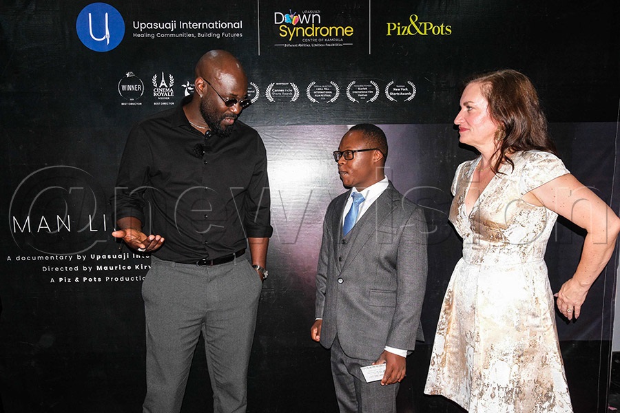 Maurice Kirya speaks with Samuel Mugabi (Sam) during the premiere of the "A Man Like Sam" documentary at Century Cinema, Acacia Mall, Kampala. PHOTO BY HAJARAH NALWADDA