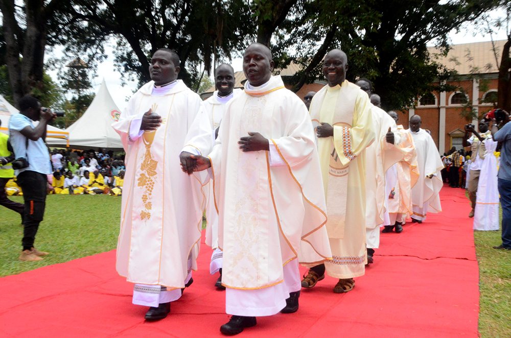 The newly ordained priests, together with their parish priests in a procession after being ordained at St Joseph's Cathedral, Gulu City. (Photo by Johnisani Ocakacon)