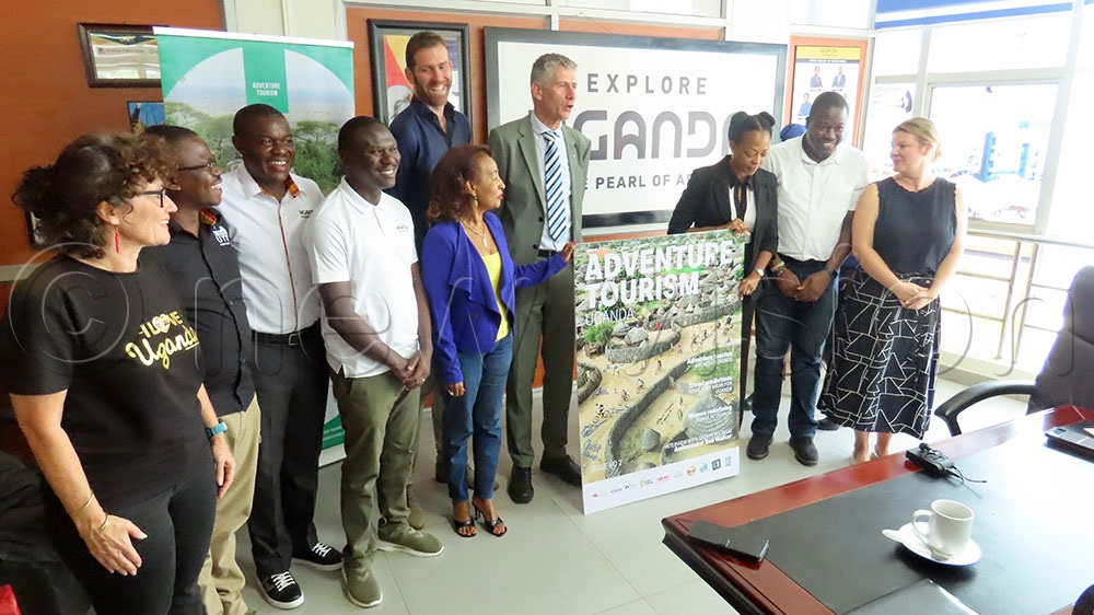 UTB CEO Juliana Kagwa and the deputy Head of Mission Bouwe-Jan have a photo moment during  the launch of the Adventure Uganda magazines at the head office. (Photo by Titus Kakembo)