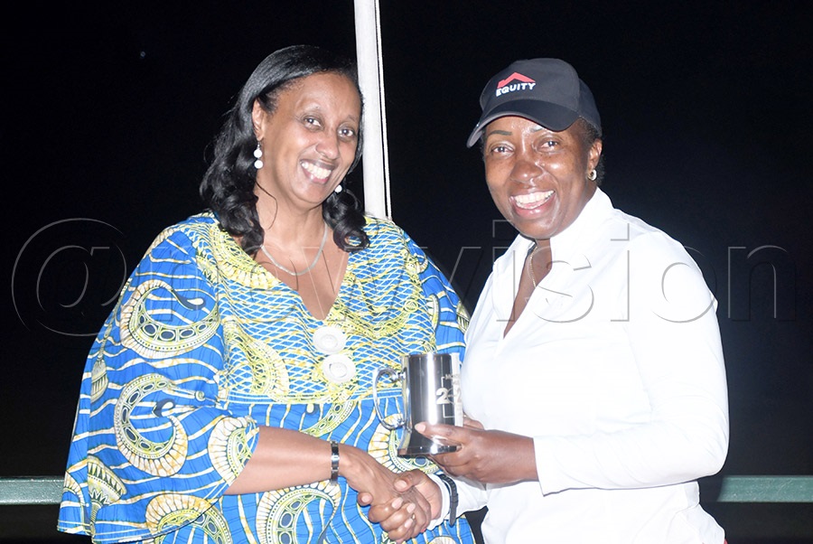 The overall winner ladies Gloria Mbaguta (right) receives her winningmug from Consolata Kareeba after the UGC October Mug at Kitante. Photo by Michael Nsubuga