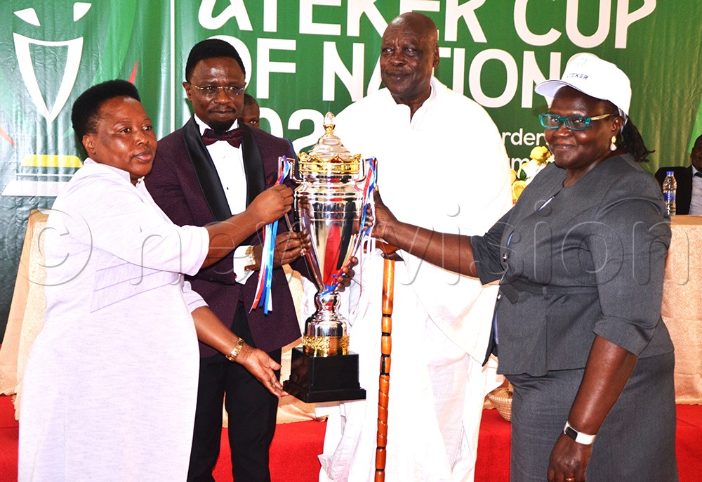 Kenyan Ambassador to Uganda, Ababu Namwamba displaying the female Ateker cup of Nations trophy in Soroti City. Looking on is Peter Lokeris and women leaders. (Credit: by Delux Emmy Alomu)