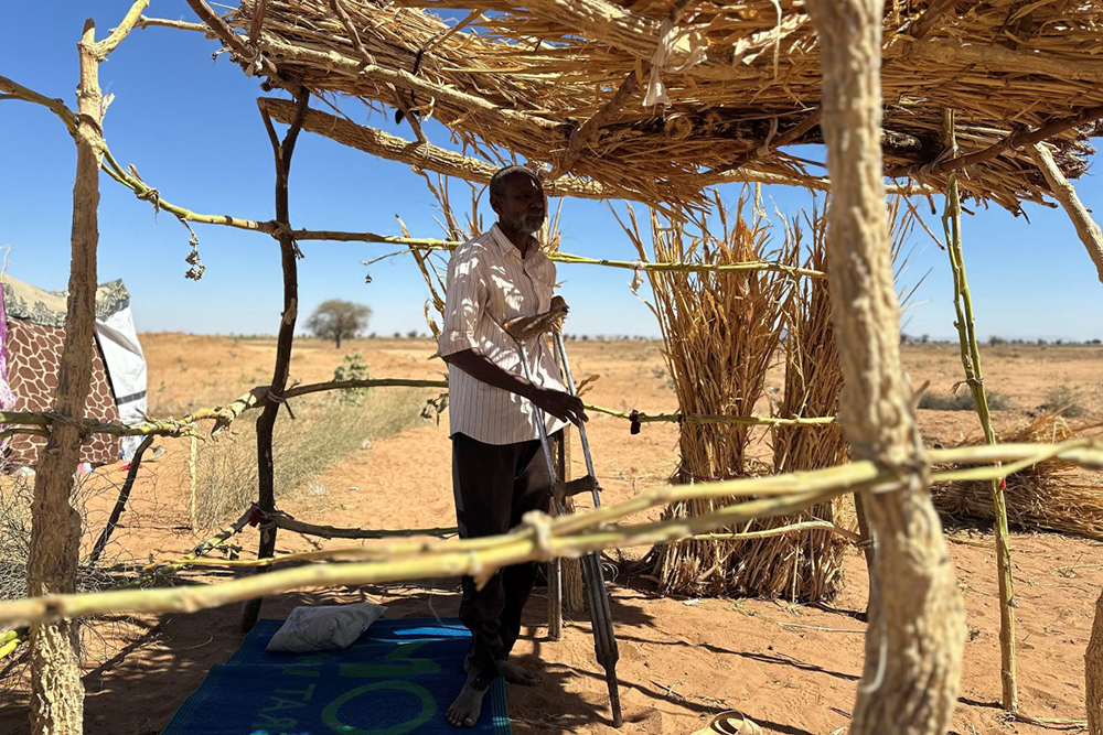 Sudanese displaced Ibrahim Noureldin, who says he was imprisoned and tortured in Rapid Support Forces' (RSF) prisons before fleeing El-Fasher, leans on crutches at a makeshift shelter in the town of Tawila, in war-torn Sudan's western Darfur region on March 2, 2026.