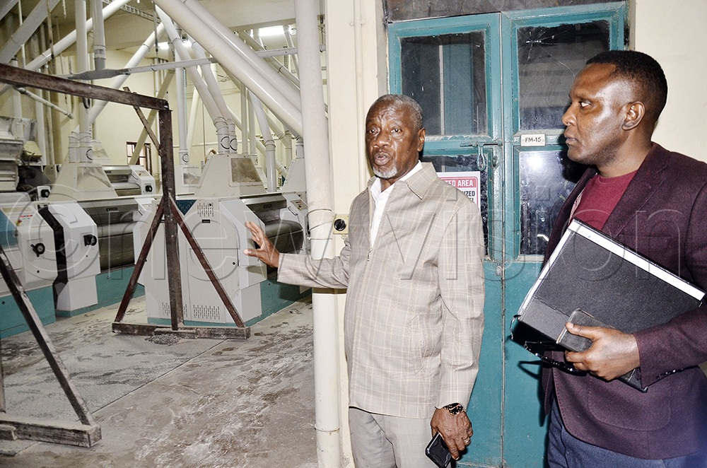 Ntake Group managing director and co-founder Gaster Lule (left) shows New Vision Business Editor Moses Mulundo machinery in the flour milling section during an interview at the company&rsquo;s offices in Nalukolongo, Lubaga Division, Kampala. (Photo by Ronnie Kijjambu)
