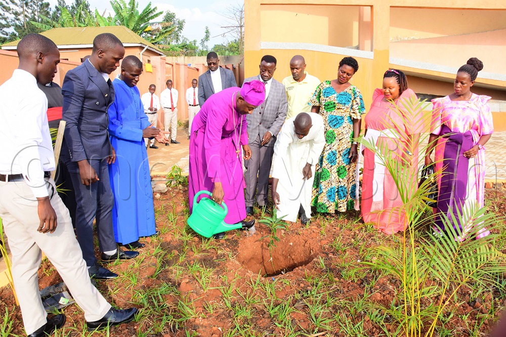 Archbishop Dr. Samuel Stephen Kaziimba Mugalu planting a tree at Muzza High School after a dedication service of senior four and six candidates. (Photo by Ritah Mukasa)