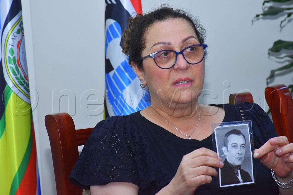 Tzipi Gonen displaying a picture of her late father Dr Pasco Cohen who was killed in a crossfire during the Entebbe raid in 1976. (Credit: Julius Luwemba)