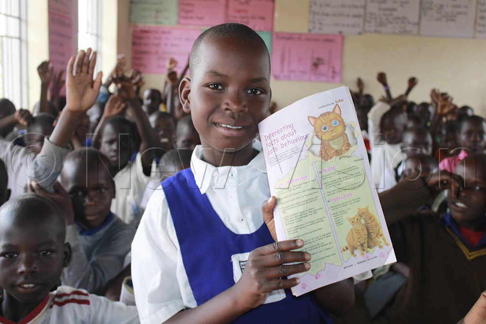 Children enjoy reading about animals in Toto Magazine. (Photo by Ritah Mukasa)