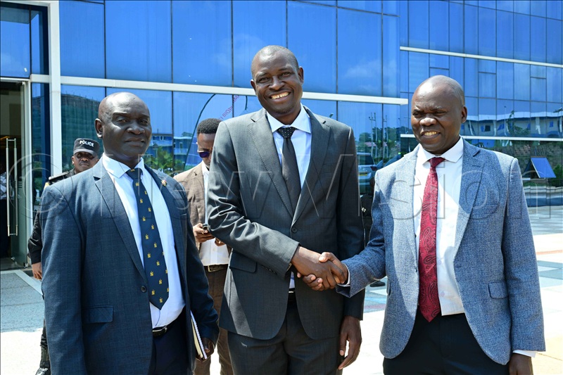 Brig General Maxwell Masuku  (R), who led a delegation from Zimbabwe shaking hands with Dr. Mathias Magoola, the founder of Dei Biopharma pharmaceutical factories in Matugga, Wakiso district. The visitors asked the company to consider making biological drugs for their country. Left is Col. Sam Kirya, the head of special operations at the Defence Intelligence and Security headquarters. 