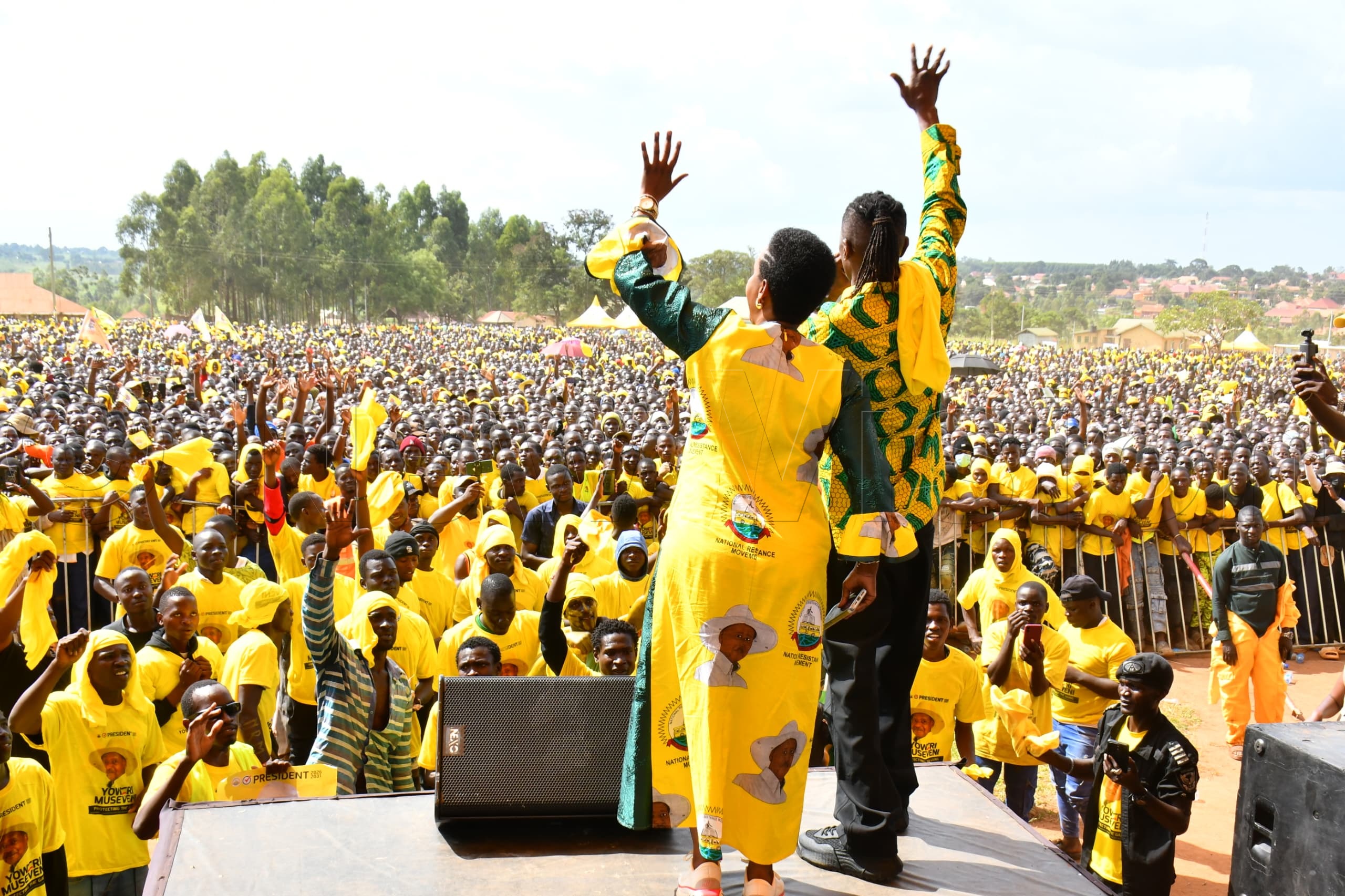 Jose Chameleon (right) and Busoga Kingdom Tourism Minister Hellen Namutamba (left) firing-up the crowd at Mayuge district headquarter ground.