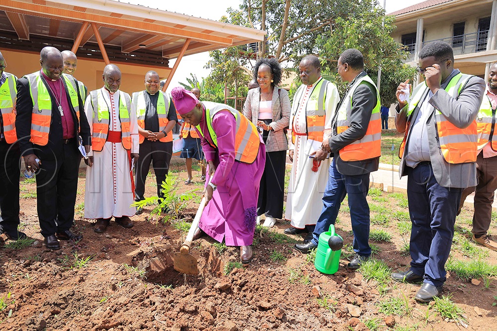 Kaziimba (centre) planting a tree at the Anglican Shrine at Namugongo. (Photo by Peter Ssaava)