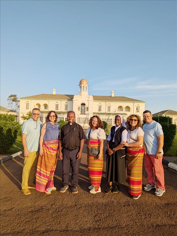 Tourists from New Jersey in Americans poses for photo with Fr Peter Ssekajjugo while at Bulange-Mengo on Tuesday, September 2, 2025.