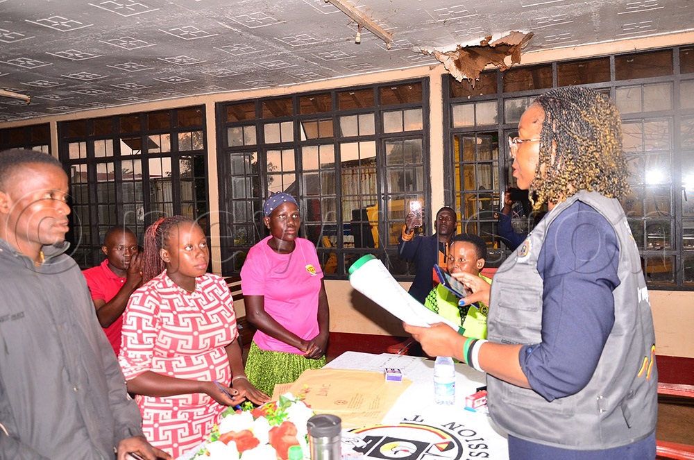 Sarah Kabakaire, the Jinja district returning officer, declaring a candidate during a heavy downpour coupled with a blackout at the Kagoma offices. (Photo by Jackie Nambogga)