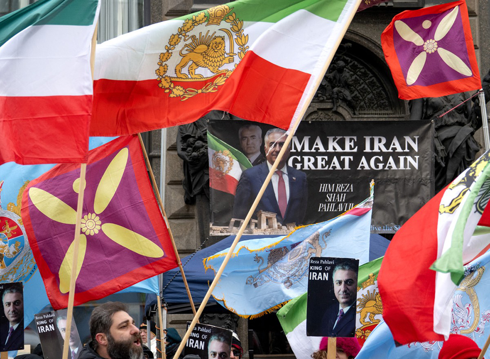 Protesters hold up placards featuring Reza Pahlavi, an Iranian dissident in exile in the United States and son of the last shah of Iran, during a demonstration against the Iranian government at Stephansplatz square in Vienna, Austria on January 11, 2026. 