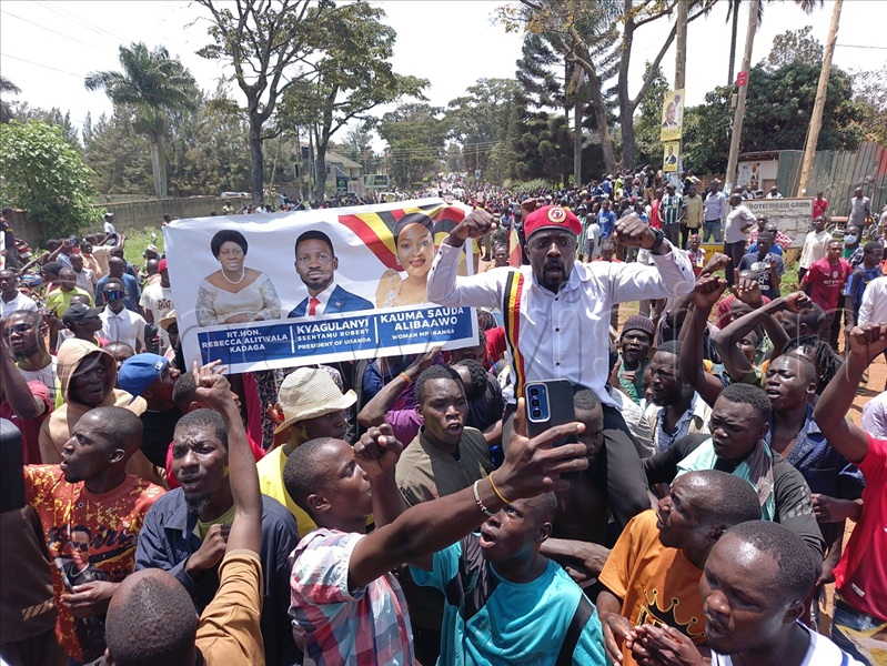 Local comedian turned politician Hussein Muyonjo of NUP was carried high by supporters who kept chanting NUP slogans while praising Kadaga in the procession. (Credit: Jackie Nambogga)