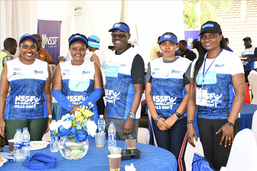 NSSF staff pose with NSSF MD Patrick Ayota (center) after the run. 