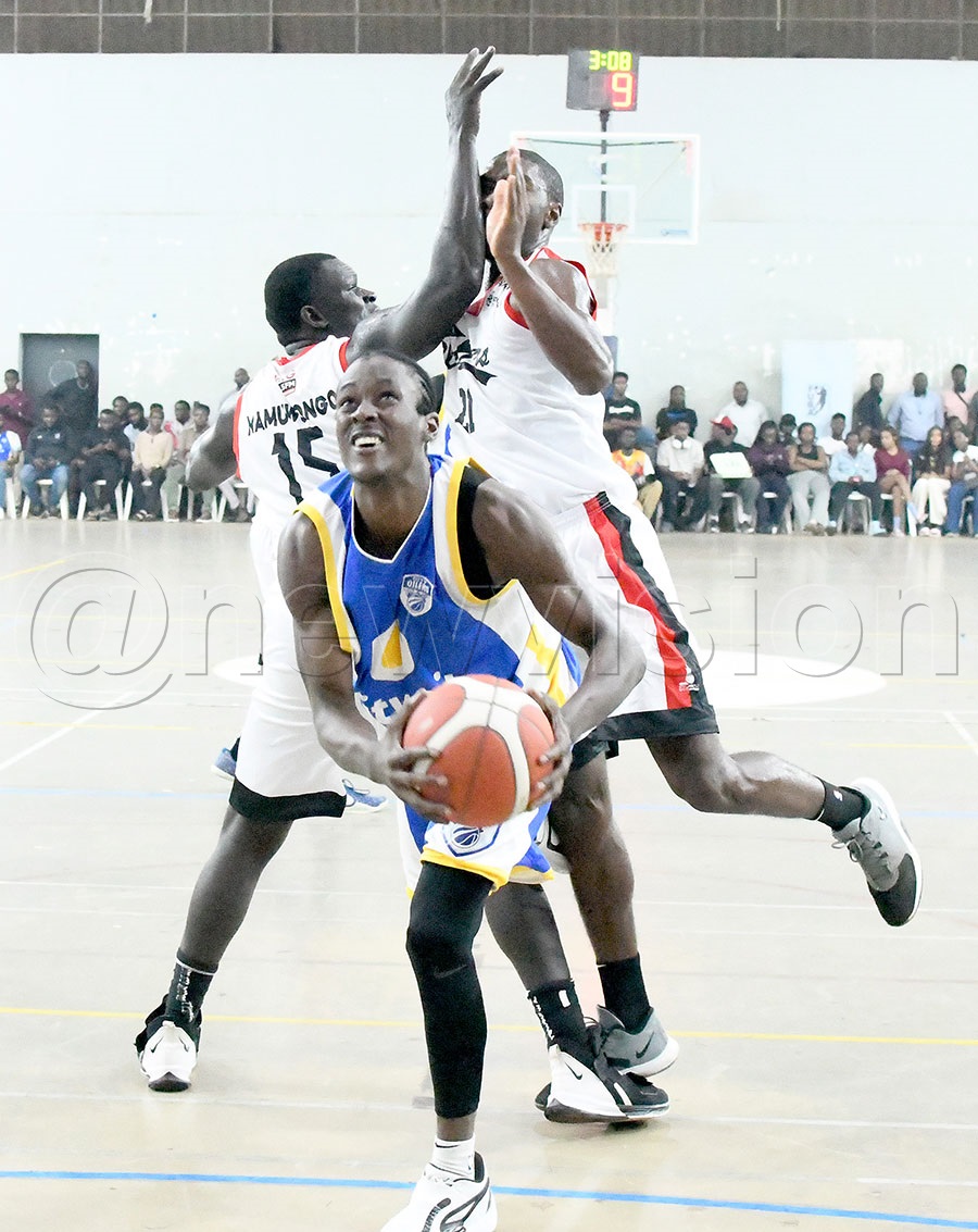 City Oilers Benjamin Kawumi lays up under pressure from  Namuwongo Blazers James Okello and Nyembo Fataki during a FUBA league match at Lugogo, February 6, 2026. Oilers won 74-65. Photo by Michael Nsubuga