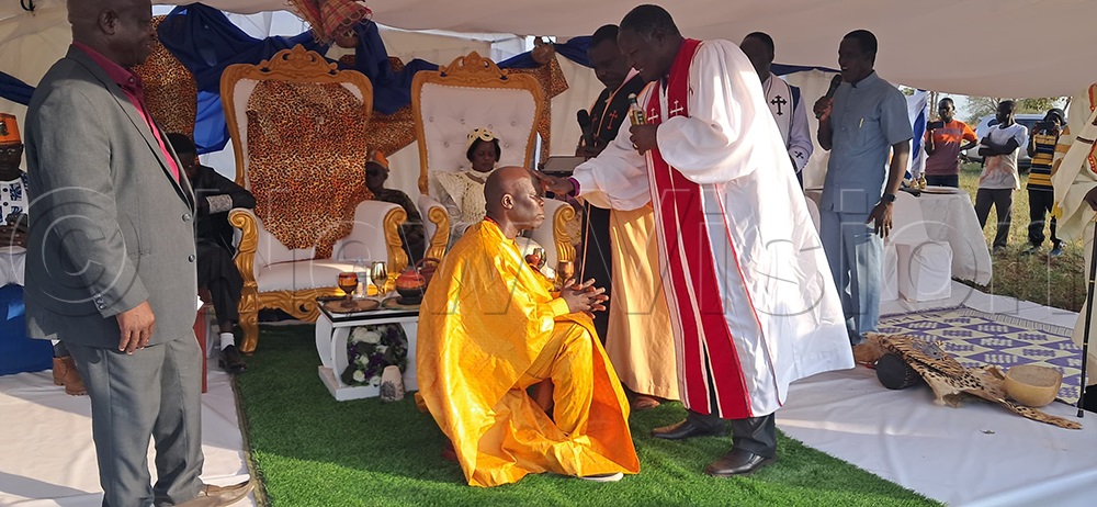 Rwot Ogik receiving blessings from a religious leader during his coronation. (Photo by Christopher Nyeko)
