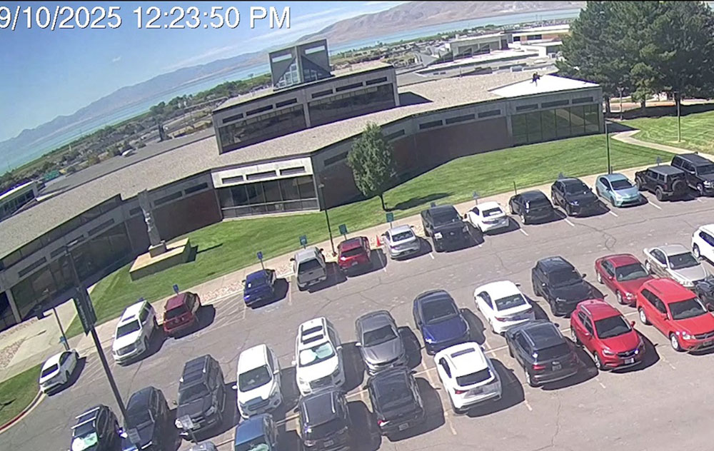 This screenshot taken from a video footage released by the Federal Bureau of Investigation (FBI) on September 11, 2025 shows a person of interest running on the roog (R) at Utah Valley University in Orem, Utah, immediately after the fatal shooting of Charlie Kirk. (Credit: AFP)