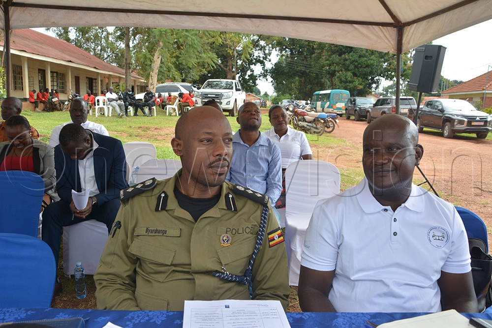Regional Chief State Attorney John Ochopa (right), whom residents demanded be transferred, sits with Albertine Region Deputy Police Commander Titus Byaruhanga during the Baraza. (Photo by Peter Abaanabasazi)