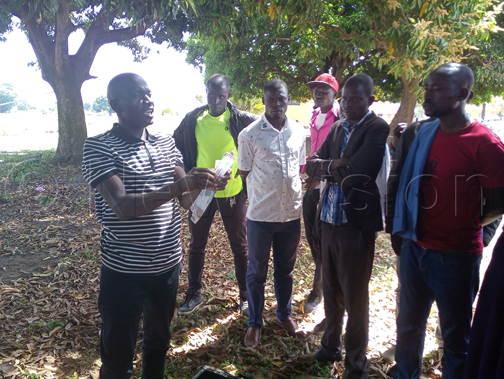 Youth witnessing the opening of the ballot box in the presence of Samuel Agau the presiding officer. (Photo by Christine Itado)
