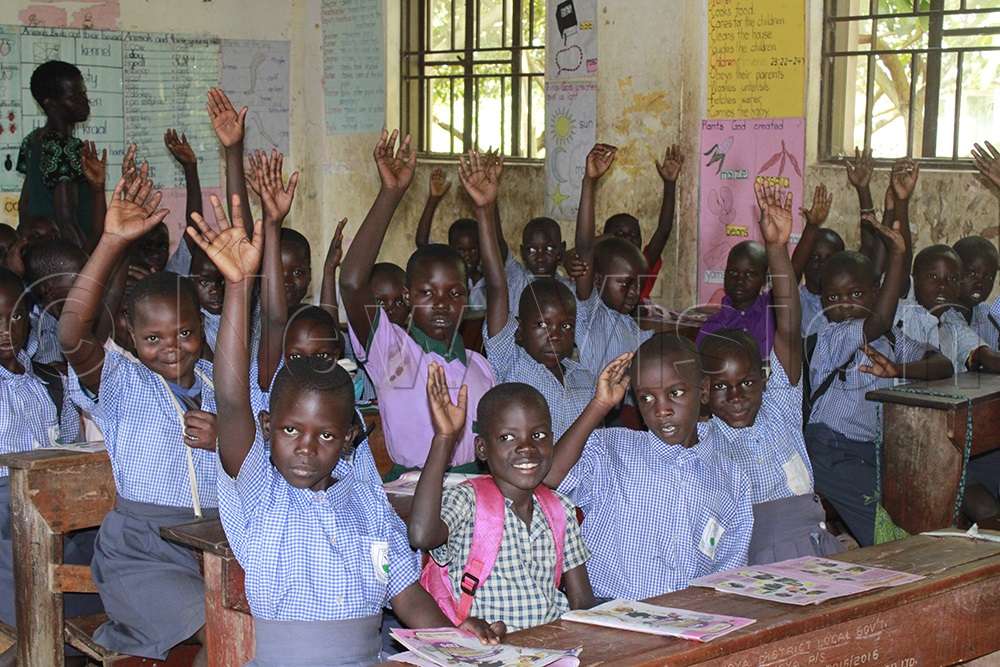 Primary One pupils at Nwoya P7 School excitedly read through Toto Magazine. (Photo by Ritah Mukasa)