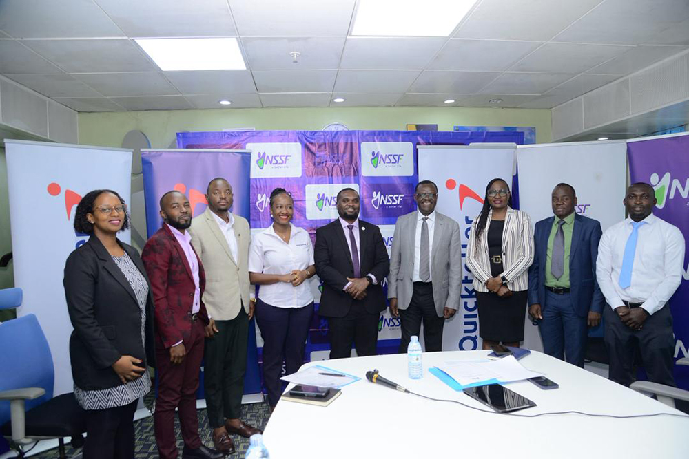 Ayota (fourth from right) and Moris (fifth from right), and other NSSF and Interswitch representatives during the partnership announcement in Kampala. (Courtesy)