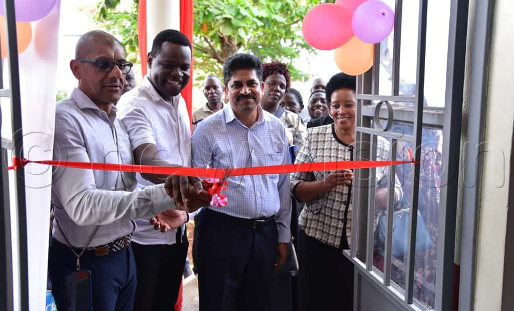 (L-R) Classic Leader Foundation, Priyesh Pravinchandra Shah, Gerald Mukamba, Educucation Officer, KCCA, Srinivasa Reddy, Director Classic, launching the newly constructed multipurpose hall. (Credit: Jovita Mirembe)