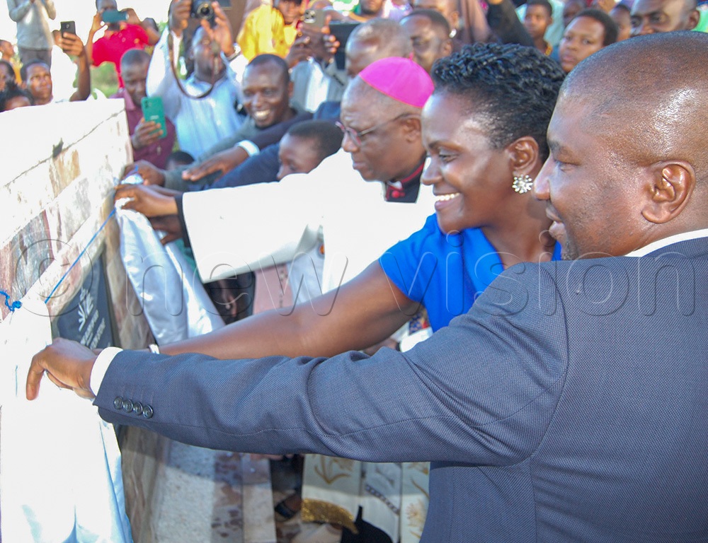 The Archbishop of Kampala, Paul Ssemogerere (wearing a skull-cap) and the head of the laity of Kampala Archdiocese Emily Kitto Mwaka (second-right) unveil the plaque of the foundation stone of the proposed elderly priests' centre at St. Francis Xavier Catholic Sub-parish church, Bweya, in Kajjansi Town Council, Wakiso district on Tuesday, May 19, 2026. (Photo by Mathias Mazinga)