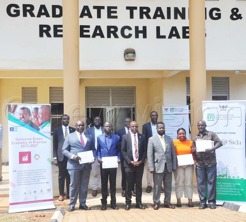 (R-L) Mboijana (First Right), Kemigisha (Second Right), Prof. Wamala (Third Right), Prof. Bbaale (Fourth Right) with officials from Makerere University, guests together with civil servants who got certificates. This was during the graduation ceremony for the 2025 Environment for Development Initiative (EfD) Inclusive Green Economy (IGE) Fellowship at the Makerere University Agricultural Research Institute at Kabanyolo. (Credit: John Odyek)