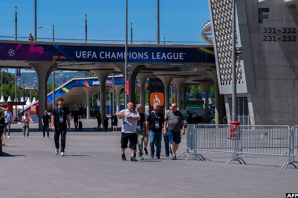 Technicians and volunteers walk around the Puskas Arena, named after Hungary's most famous footballer Ferenc Puskas, ahead of Saturday's Champions League final