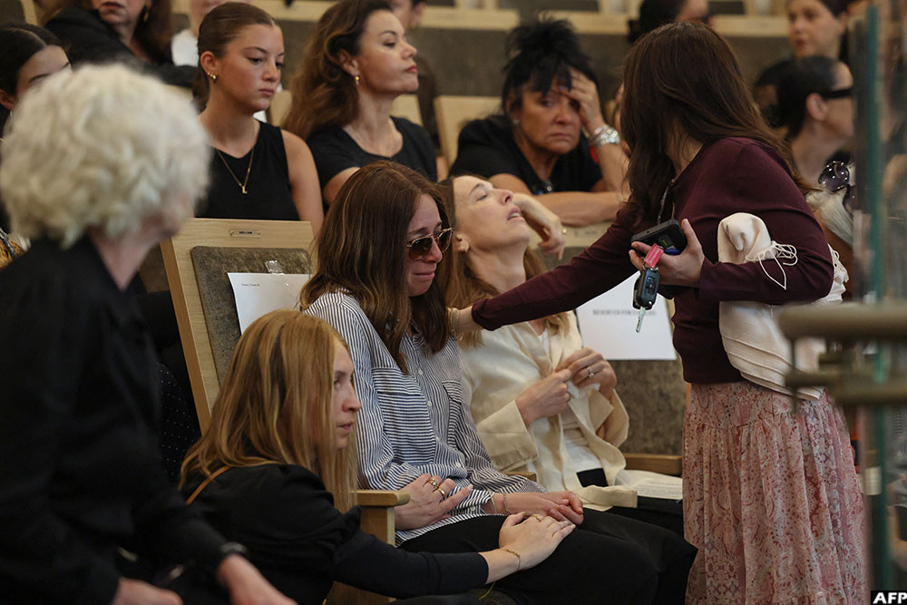 Relatives of rabbi Eli Schlanger, who was killed in the December 14 Bondi beach shooting attack, weep during his funeral at the Chabad of Bondi Synagogue in Sydney.