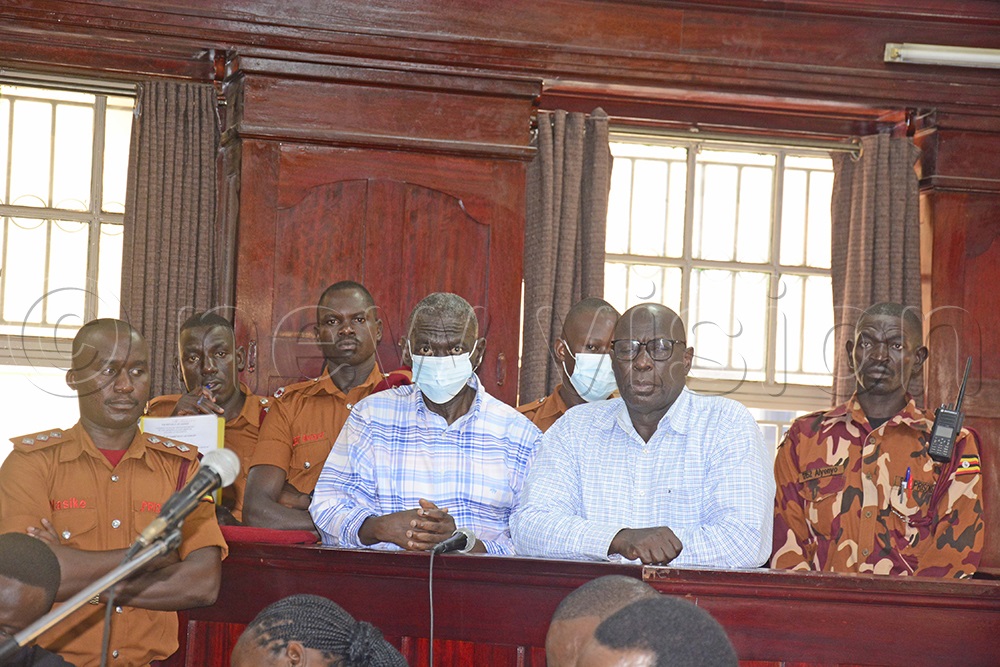 Dr Kizza Besigye (left) and his aide, Hajj Obeid Lutale who are facing charges of treason and misprision of treason, appearing at high court, Kampala for bail application on Friday, March 14, 2025.  Photo by Margaret Zalwango)