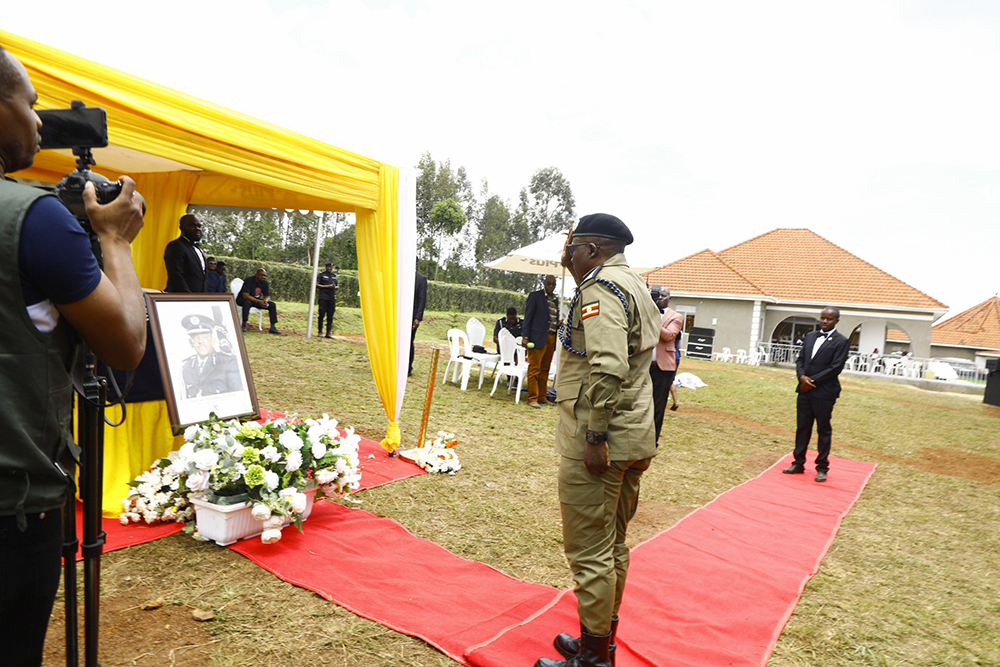 Inspector General of Uganda Police Force paying last respects to the late AIGP Charles Kataratambi during the funeral on Saturday at the family home in Kanga Village, Kashari, Mbarara. (Courtesy)