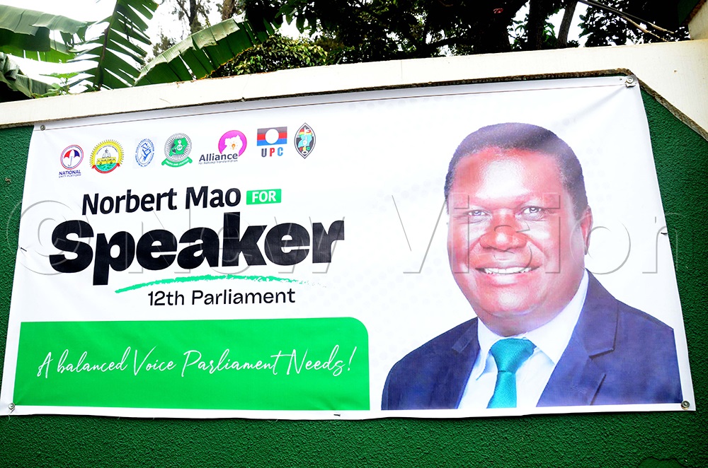 Justice and Constitutional Affairs Minister, Nobert Mao, portrait with opposition party logos at DP party headquarters on Balintuma Road in Rubaga division, Kampala, on Tuesday, Feb. 24, 2026. (Photos by Isaac Nuwagaba)