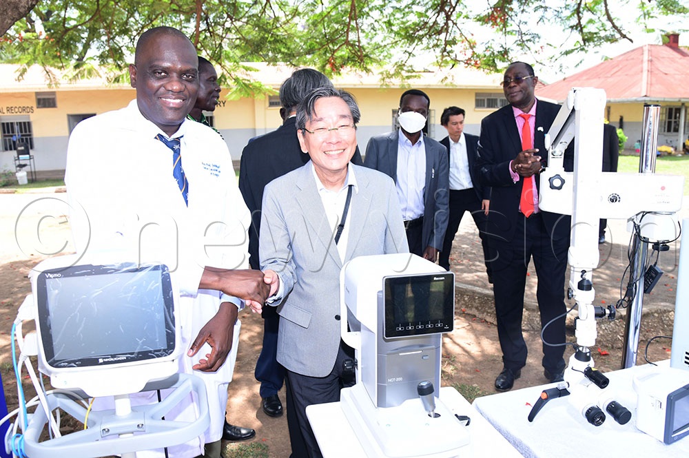Senior Consultant Surgeon and Urologist Dr Joseph Epodoi interacts with Ambassador Takuya Sasayama after handing over the equipment. (Credit: Godfrey Ojore)
