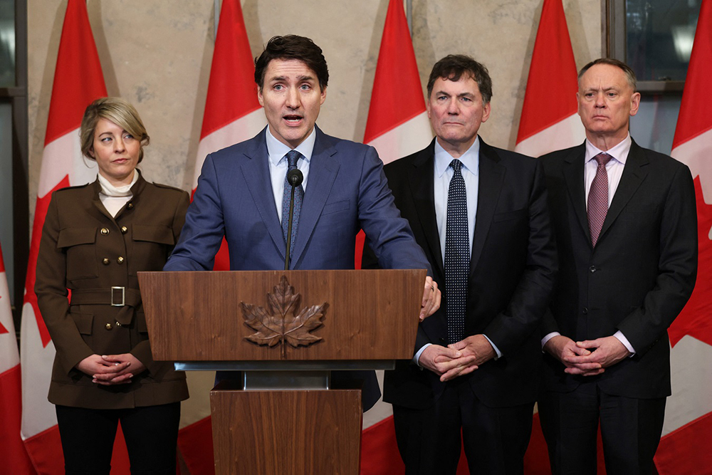  Canada's Prime Minister Justin Trudeau speaks during a news conference about the US tariffs against Canada on March 4, 2025 on Parliament Hill in Ottawa, as (L-R) Foreign Minister Melanie Joly, Minister of Finance and Intergovernmental Affairs Dominic Leblanc and Minister of Public Safety David McGuinty look on. Trudeau said that President Donald Trump imposed tariffs on Canada to destroy the country's economy to make it easier for the United States to annex its northern neighbor. 