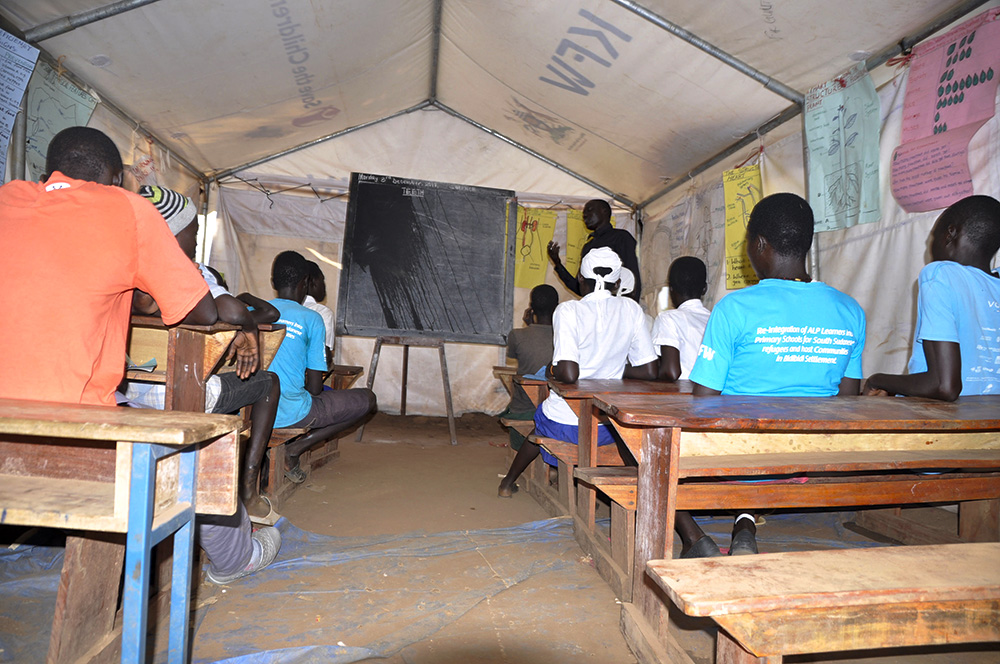 Pupils attending class at Yoyo Primary AEP centre in Bidi Bidi refugee settlement
