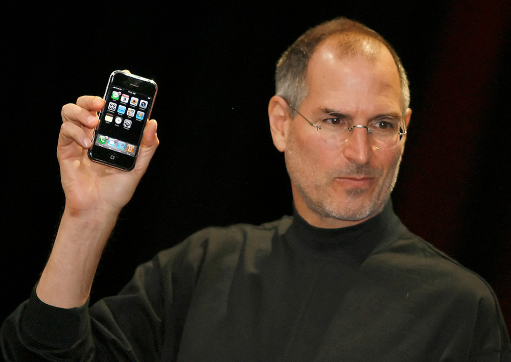 Apple chief executive Steve Jobs unveils a new mobile phone that can also be used as a digital music player and a camera, a long-anticipated device dubbed an "iPhone" at the Macworld Conference in San Francisco, on January 9, 2007.