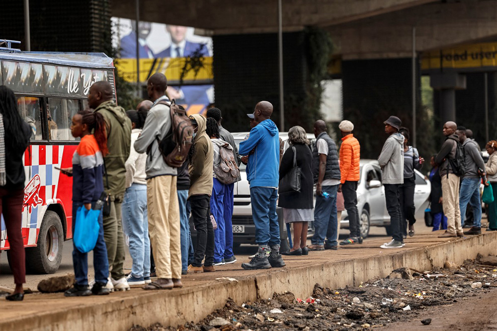 Kenyans wait for public tranpsort during a nationwide transport strike over rising fuel prices in Nairobi on May 18, 2026. Public transport was largely shut down and protesters barricaded roads in Kenya on May 18, 2026 as a strike was called over a fuel price hike triggered by the Middle East war. (Photo by SIMON MAINA / AFP)
