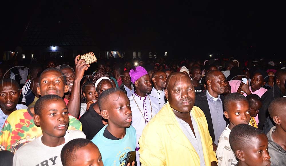 Busoga diocesan bishop, the Rt. Rev. Prof. Grace Lubaale (with top purple gear) outside the Cathedral with Anglicans as they ushered in the New Year. (Credit: Jackie Nambogga)