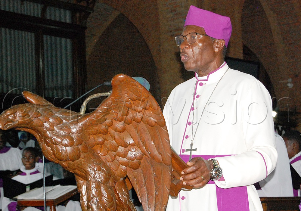 Bishop Emeritus Wilberforce Kityo Luwalira reads a scripture. (Photo by Mathias Mazinga)