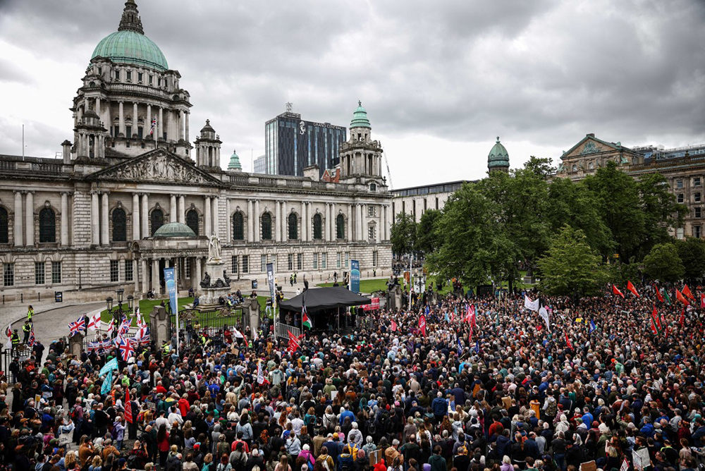 People turn out for a demonstration against racism and call for calm in central Belfast, Northern Ireland on June 13, 2026, after a few nights of disorder hit the city when video of a knife attack on June 8 went viral across social media platforms. Thousands of people on June 13 gathered for an anti-racism rally in the Northern Irish city of Belfast after unrest sparked by a horrific stabbing. (AFP)