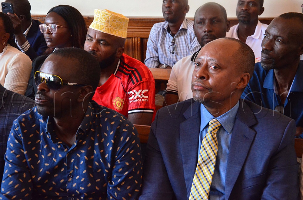 Dr Mwesigwa Robert Rukaari (in a necktie), who dragged  Christopher Bakashaba, the MP for Mbarara City North Constituency, to Mbarara High Court over forgery and fraudulently obtaining academic documents. (Photo by Fred Turyakira)
